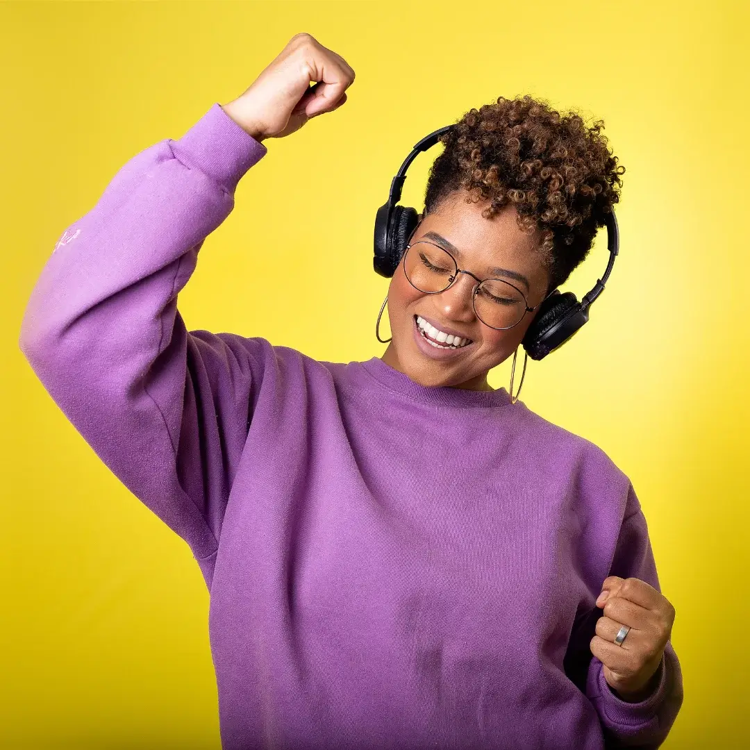 A black woman enjoying rock and roll music.